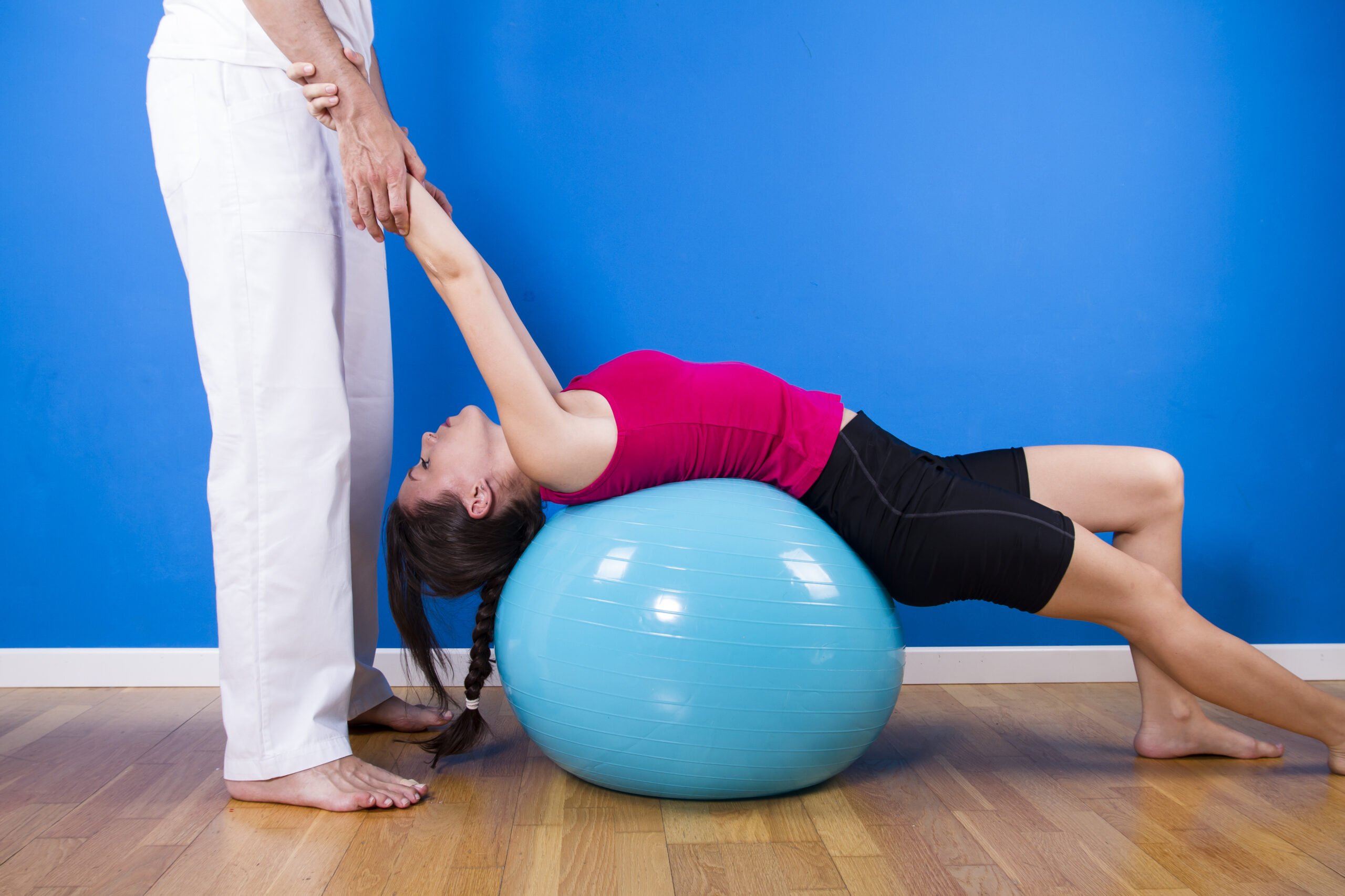 portrait of a young pretty couple, fitness indoor, exercise ball